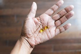 woman holding vitamin d gels
