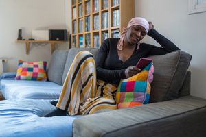 Woman with scarf on her head looking at her phone