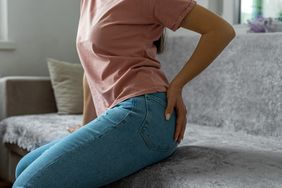 Woman hand holding her bottom 