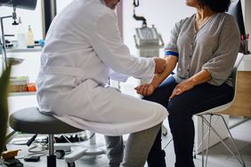woman gets blood drawn at doctor's office