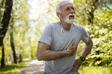 Senior man athlete having heart problems during exercise