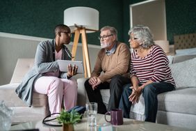 nurse talking to senior couple