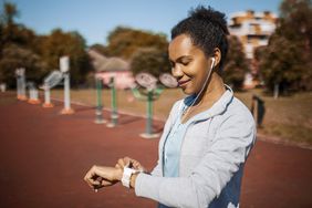 Woman checking her heart rate on her fitness watch after exercising.