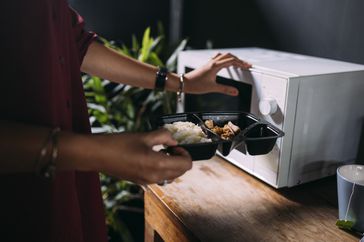 Black plastic container into microwave
