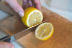 Person chopping a lemon
