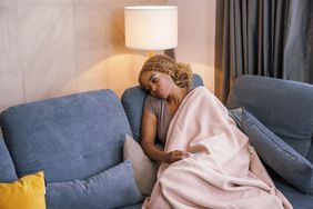 Person lying on couch sick.