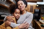 Mother hugs daughter who seems depressed. 