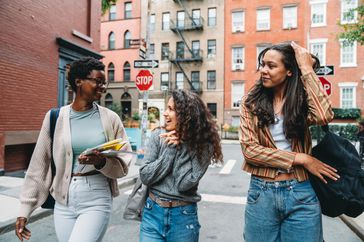 Photo of a group of young adults walking together down a city street