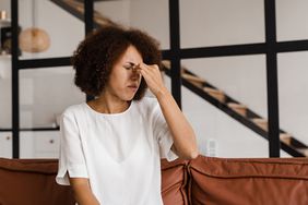 Woman with sinusitis holding her stuffy nose