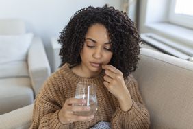 a person taking a supplement