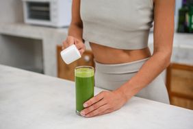 a person adding powder to their drink