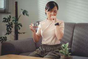 person with a dry throat drinking water