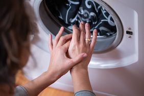 Person with eczema on their hands does the laundry.