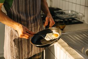 man cooking eggs