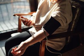 woman taking blood pressure at home