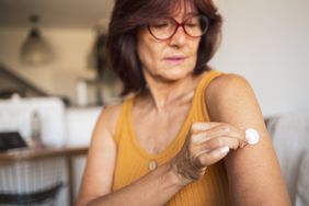 person with menopause using patch for hormone replacement therapy