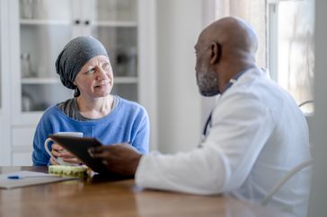 A doctor talks to a woman with cancer