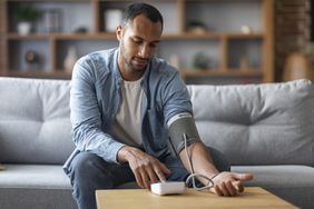 Person checking blood pressure at home