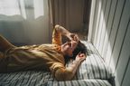 Tired woman lies on the bed