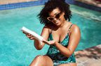 Woman applies sunscreen at the pool