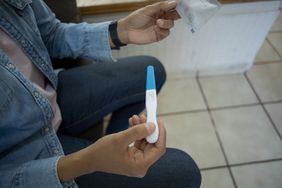woman reading pregnancy test
