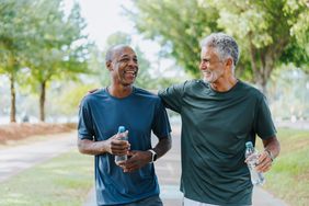 Two men walk in park