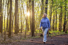 woman walking in a park at sunset