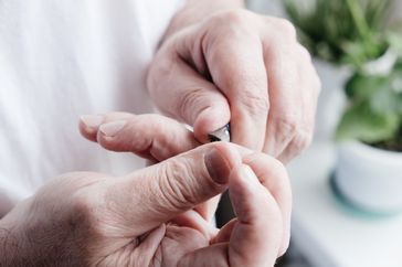 Person taking care of nail psoriasis