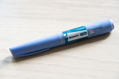 An Ozempic injection pen on a table.