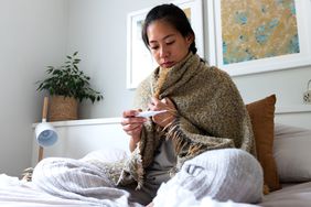 woman taking temperature