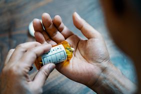 pill bottle pouring medication into hand