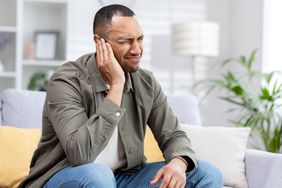 person with ear pain when swallowing