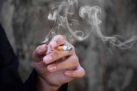 A hand holding a cigarette