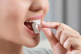 a person eating a piece of gum
