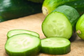Sliced cucumbers on a cutting board.