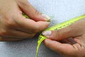 Woman measuring her waist.