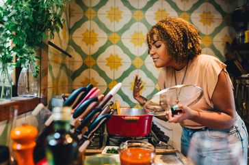 Person with PCOS cooking a healthy meal to support weight loss