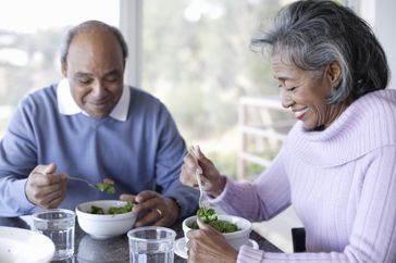 Couple eats salads for lunch.