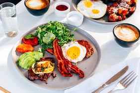 Plate with ground beef, avocado, bacon, halloumi cheese, tomato, and spinach.