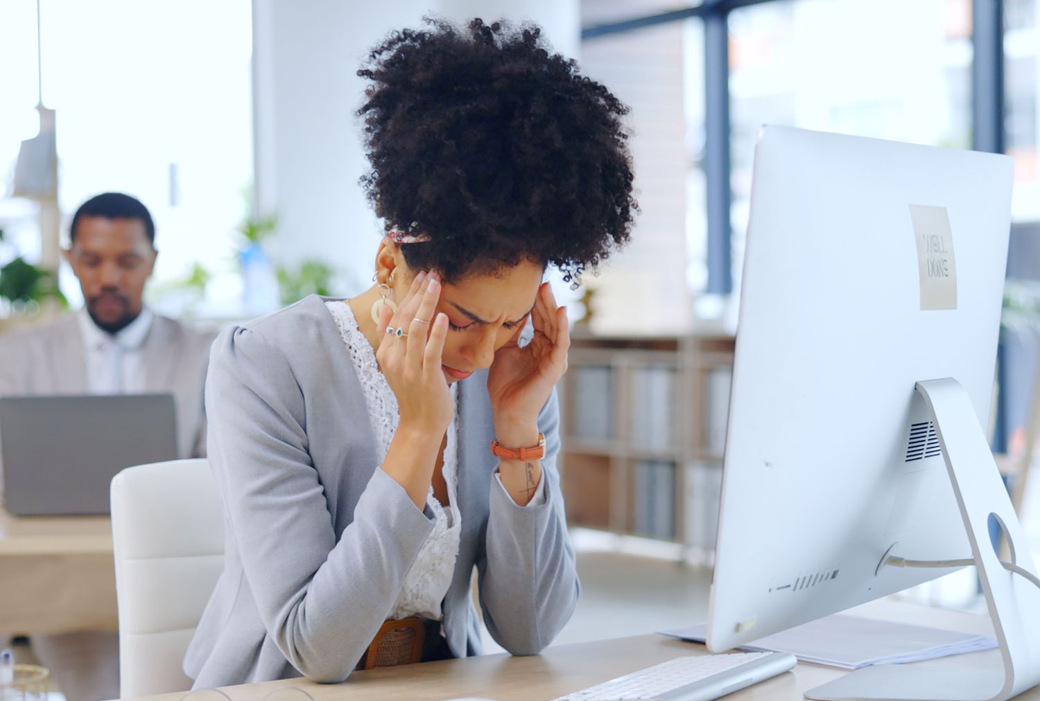 Woman at desk with headache