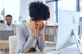 Woman at desk with headache