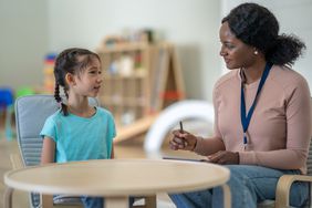 Speech-language pathologist working with child on echolalia