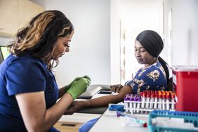 Nurse drawing blood from a patient in a medical office