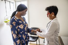 Doctor examining patient's hand