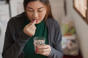 a person taking a supplement