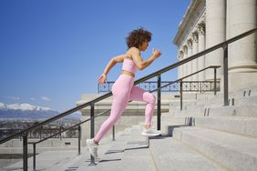 woman running up steps.