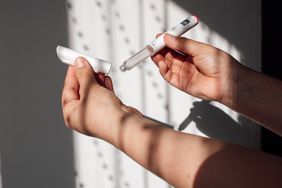 Hands holding GLP-1 injection pen for obesity