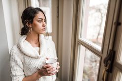 sad woman at window winter