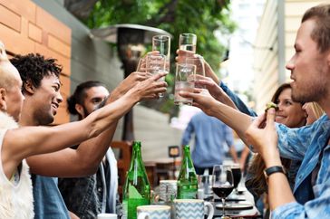Group of friends cheers with water