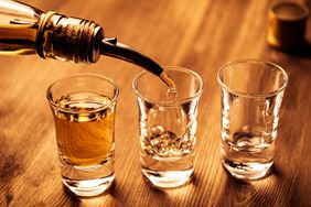 shot glasses being filled with liquor